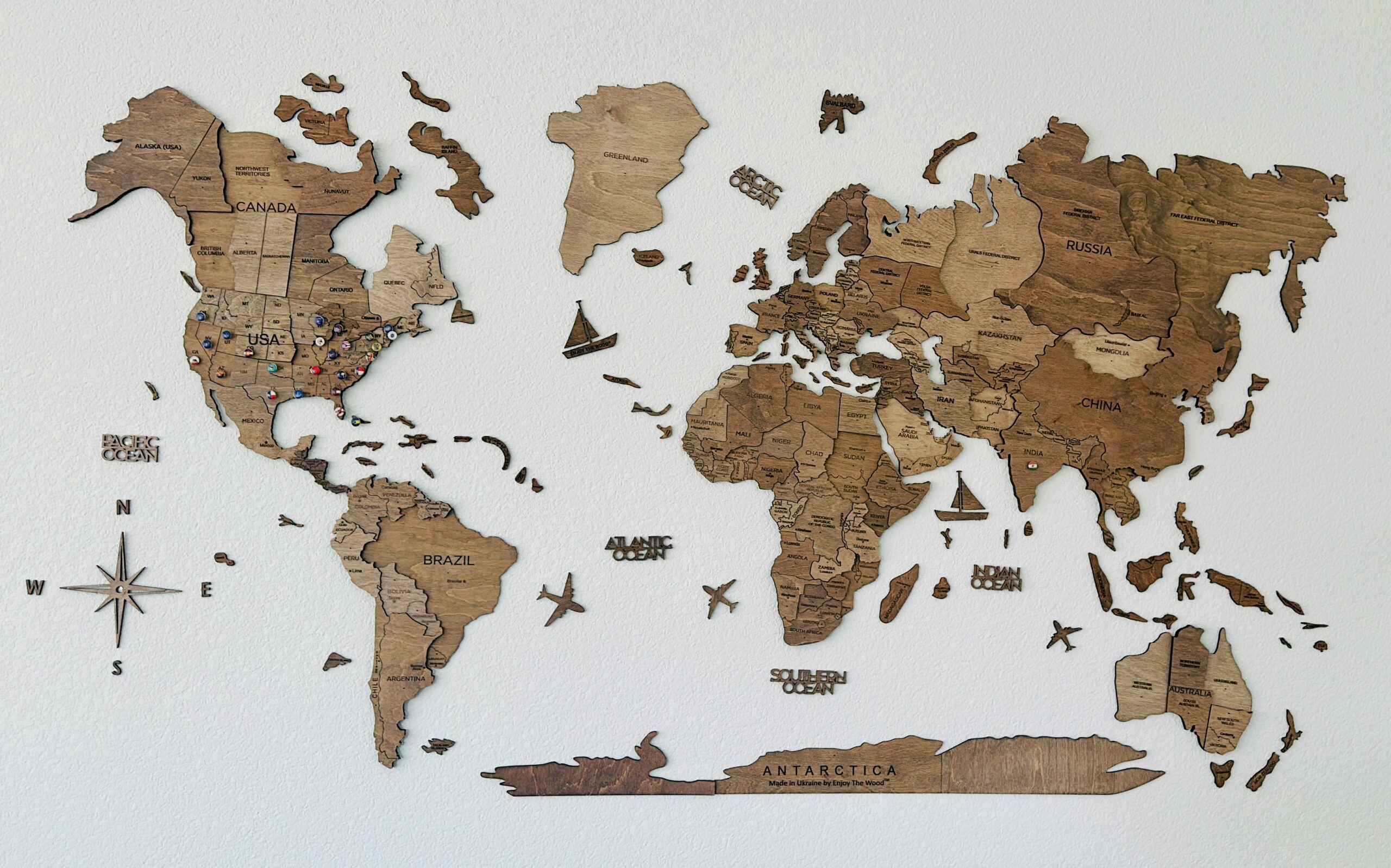 A flat, world map made out of custom-stained wood pieces for each country